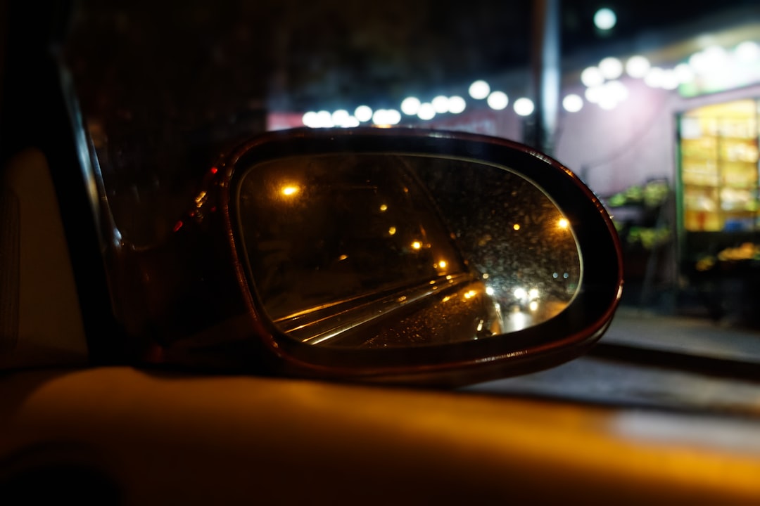 a car's side view mirror is shown at night