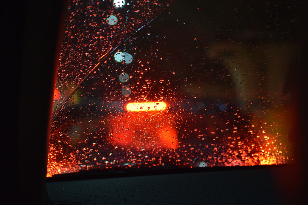A view of a street through a rain covered window